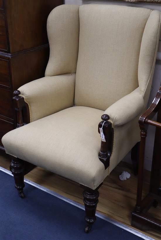 A Victorian rosewood upholstered wing armchair